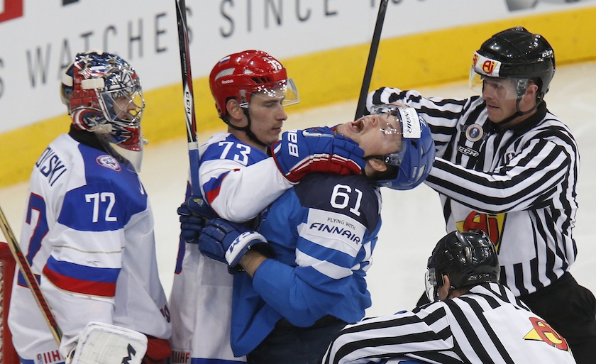 Russia's goalie Sergei Bobrovski (left) looks on as his team mate Maxim Chudinov scuffles with Finland's Tommi Huntala during the first period of their men's ice hockey World Championship final game at Minsk Arena in Minsk in this May 25, 2014 file photo.