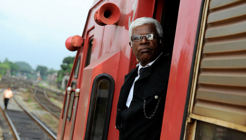 Sri Lankan railway guard Wanigaratne Karunatilleke looks on before his train departs the Colombo railway station December 15, 2014. u00e2u20acu201d AFP picn