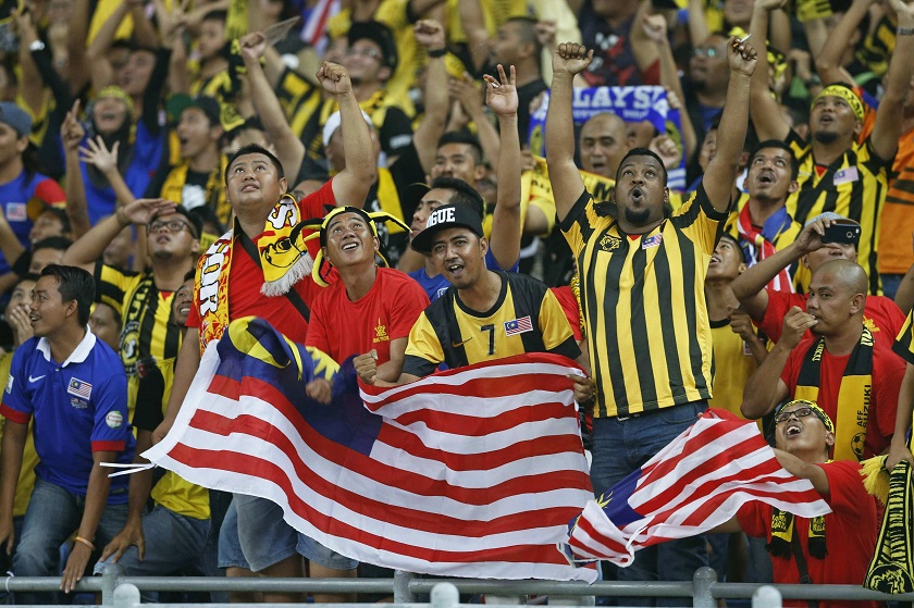 Malaysian fans cheer after the team scores the third goal during their Suzuki Cup final match against Thailand at Bukit Jalil stadium in Kuala Lumpur, December 21, 2014. u00e2u20acu201d Reuters pic