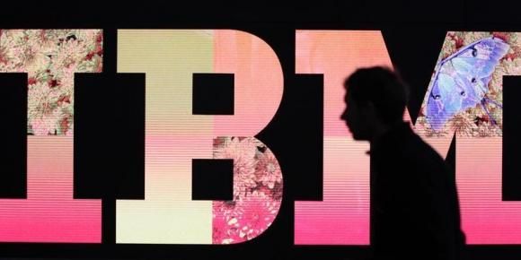 A man passes by an illuminated IBM logo at the CeBIT computer fair in Hanover February 27, 2011.nReuters/Tobias Schwarzn