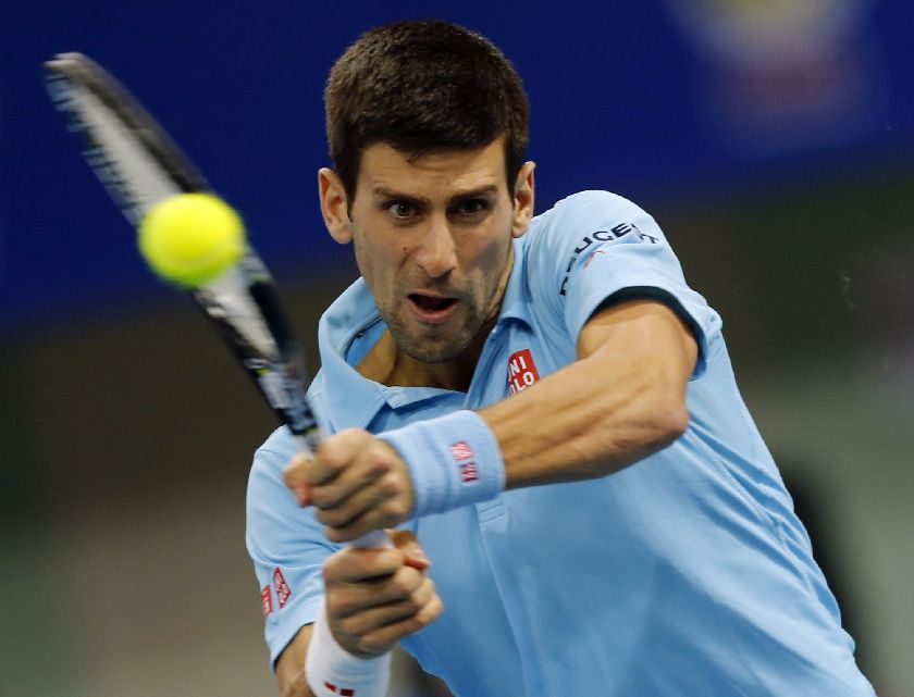 Novak Djokovic of the UAE Royals hits a return to Gael Monfis, playing for Indian Aces, in their International Premier Tennis League match in Dubai December 13, 2014. REUTERS/Ahmed Jadallah