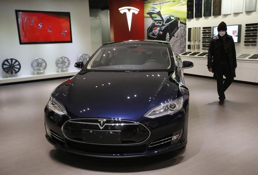A man looks at Tesla Motors' Model S P85 at its showroom in Beijing January 29, 2014. u00e2u20acu201d Reuters pic