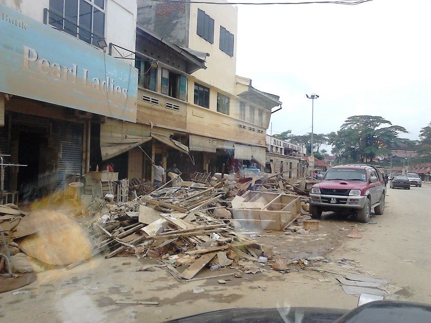 Shops with mountains of debris is seen at Kuala Krai town, January 1, 2015. — Picture by Jules Ong