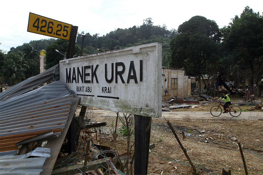 A signpost points the direction to Manek Urai.