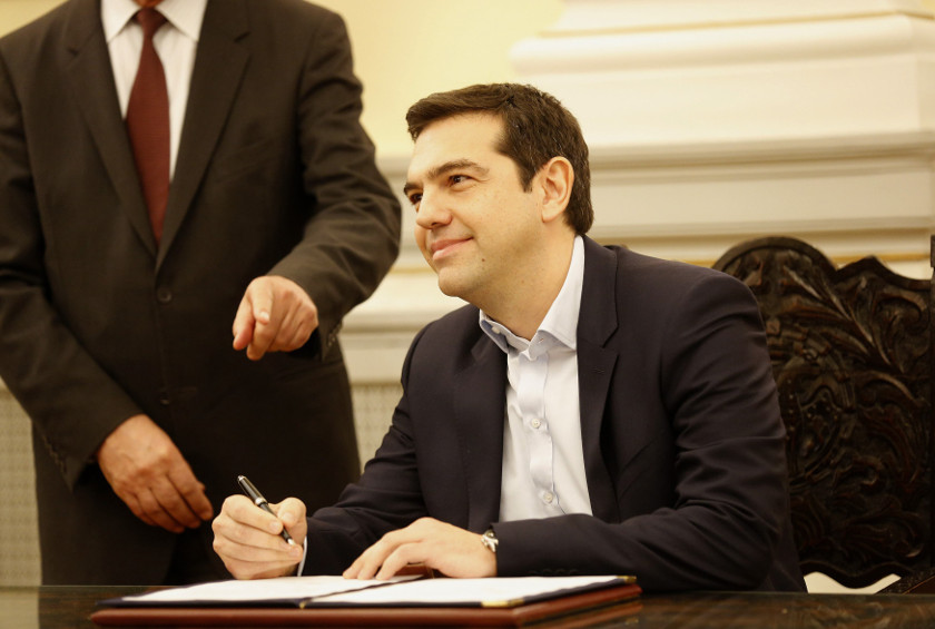 Alexis Tsipras, Syriza party leader and winner of the Greek parliamentary elections, signs papers appointing him as Greece's first leftist prime minister after his swearing-in ceremony at the presidential palace in Athens January 26, 2015. — Reuters pic