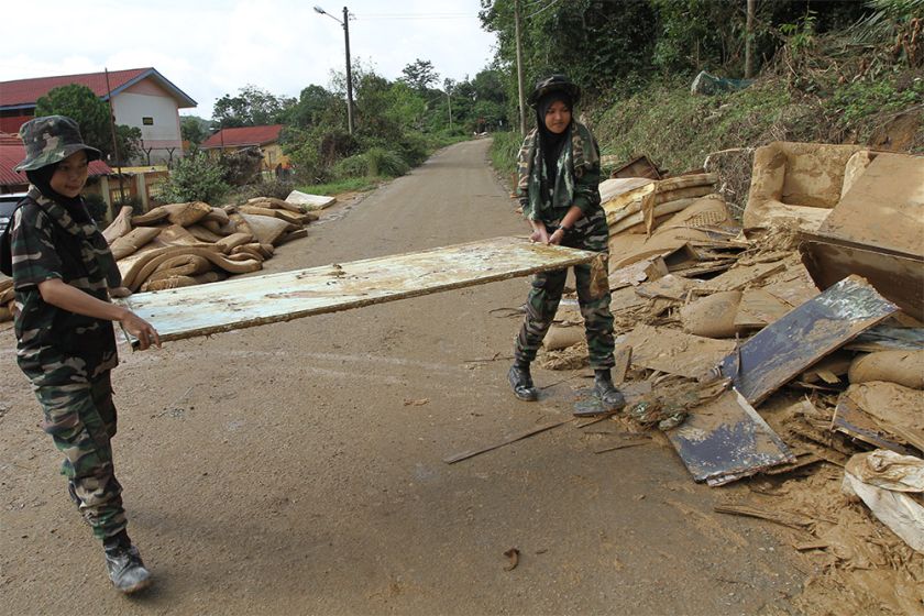 Army men and women were seen bringing out water-damaged furniture and mattresses to a dumping ground across the road. 
