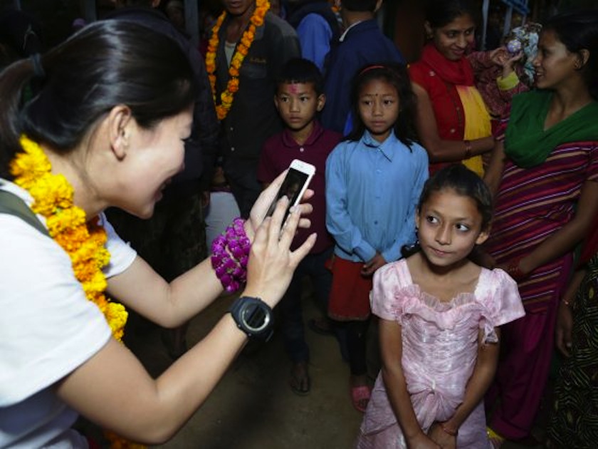 One for the album, Belinda Lee snaps a photo of Pramila. 