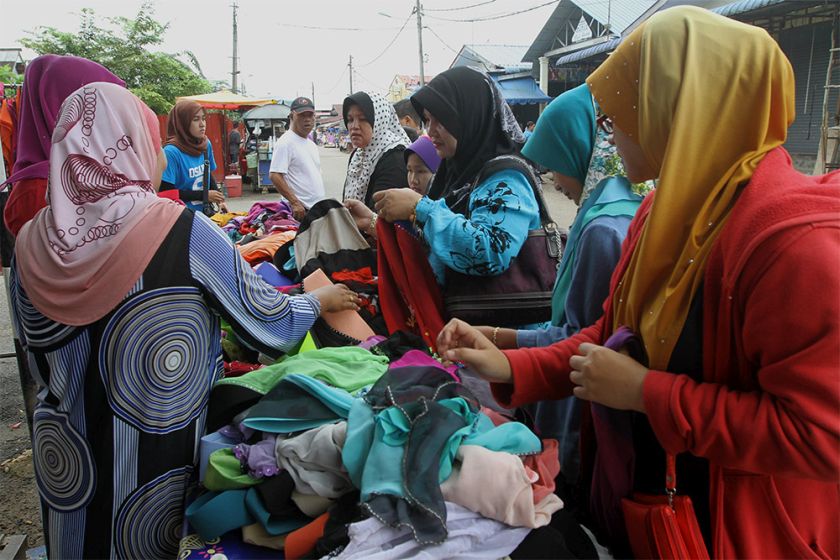 Shoppers go through clothes on sale at a street stall in Rantau Panjang, Kelantan. — Picture by Yusof Mat Isa
