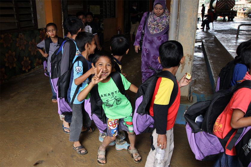 Students of SK Manek Urai are clad in colourful casual attire and rubber slippers instead of the usual white-and-navy-blue uniforms. 