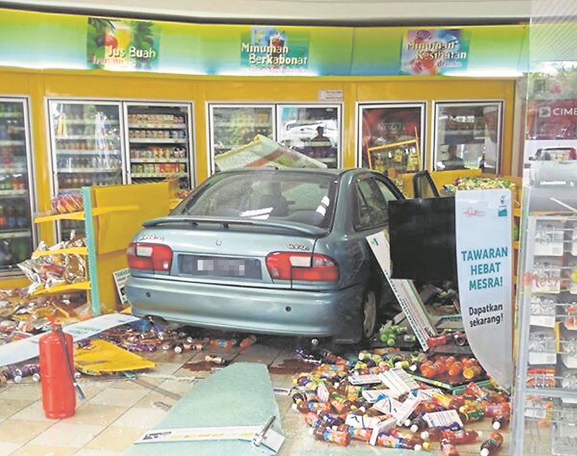 The car ended up inside the Mesra mart after the driver accidentally engaged the gear to drive mode instead of reverse. u00e2u20acu201d Picture by Malay Mail
