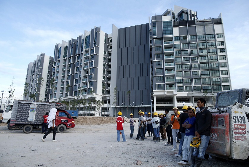 Workers wait to start work outside a soon-to-be-completed condominium project at Kota Iskandar in Johor, February 27, 2015. u00e2u20acu201d Reuters pic