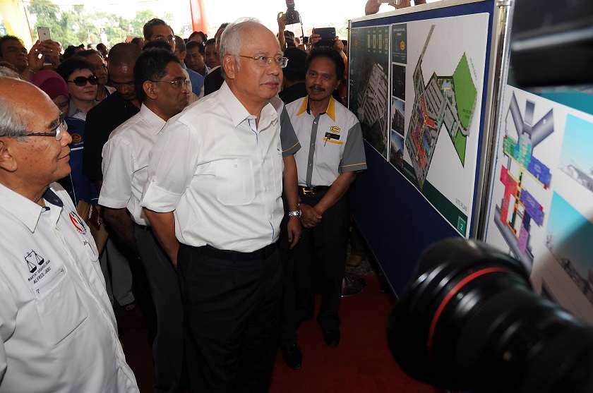 Prime Minister Datuk Seri Najib Razak looks at hospital floor plans on display during the ground breaking ceremony for the Sri Aman Hospital in Sarawak, February 27, 2015. u00e2u20acu201d Bernama pic