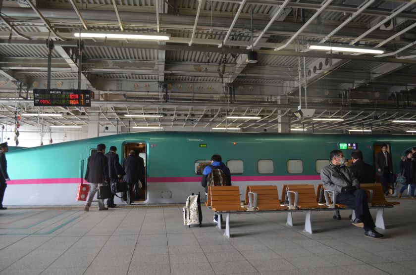 Caption for 0299: Passengers boarding a Series E5 bullet train, with the model affectionately called ,Hayabusa, or the Falcon, capable of reaching speeds of 320km per hour. u00e2u20acu201d Picture by Ida Lim.