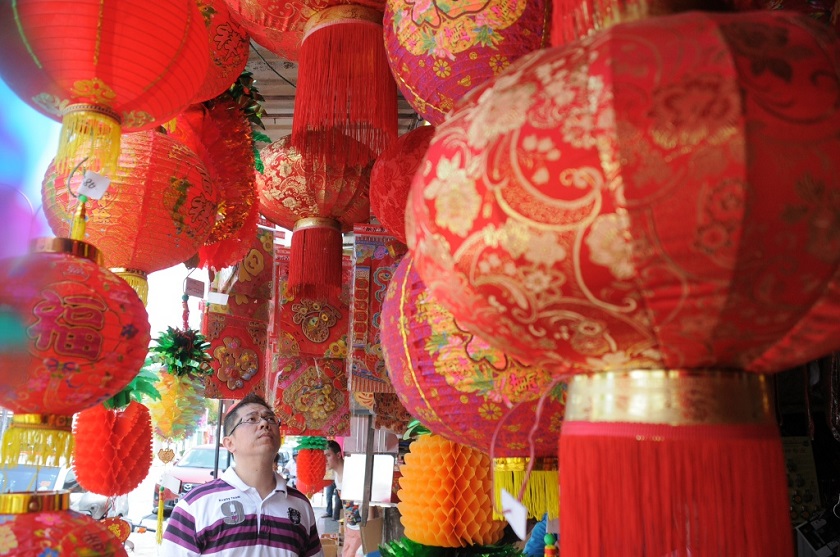 A man selects from various brightly-coloured Chinese New Year lanterns sold at a shop in Penang, February 17, 2015. u00e2u20acu201d Picture by K.E. Ooi