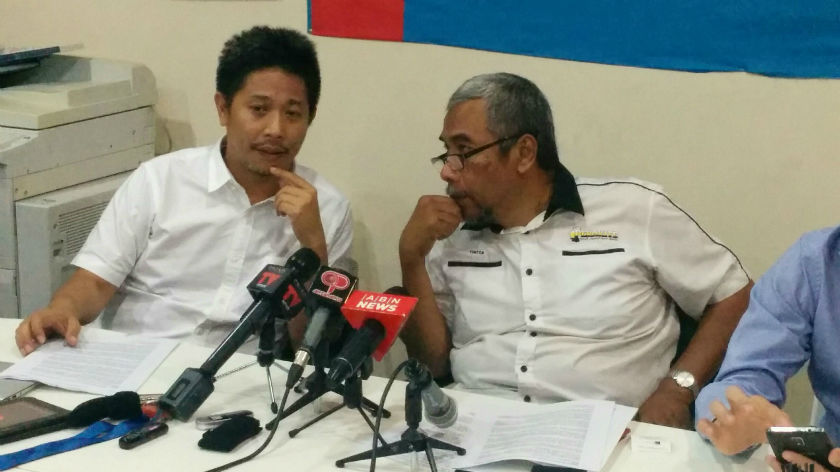 PKRu00e2u20acu2122s Gooi Hsiao Leung (left) speaks to PASu00e2u20acu2122 Dr. Hatta Ramli before a press conference called to demand that lawyer Tan Sri Muhammad Shafee Abdullah step down as chairman of an ASEAN intergovernmental committee on Human Rights. u00e2u20acu201d Picture by Mayuri M