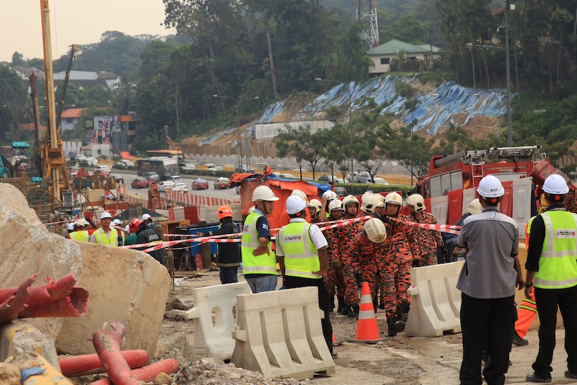 Workers and emergency services personnel are pictured at the MRT Semantan construction site following an accident in Kuala Lumpur February 27, 2015. u00e2u20acu201d Picture by Saw Siow Feng