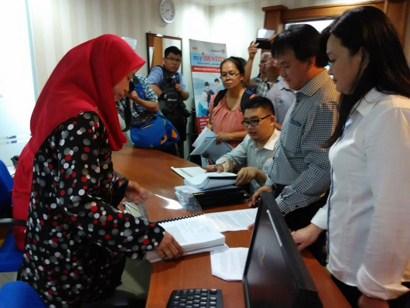 Sarawak PKR vice chairman Ali Biju (second right) submits petitions to State Election administrative assistant Salbiah Abang Madni, in Kuching. u00e2u20acu201d Picture by Sulok Tawie