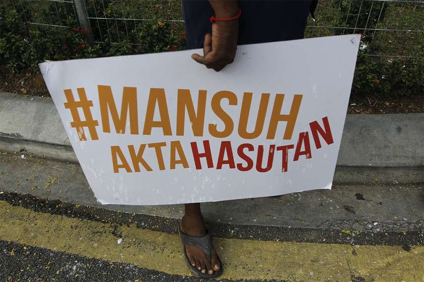 A supporter holds a placard calling for the abolishment of the Sedition Act after Parti Socialis Malaysia (PSM) Secretary-General S. Arutchelvan was arrested in Dang Wangi, Kuala Lumpur, on February 20, 2015. u00e2u20acu201d Picture by Yusof Mat Isa