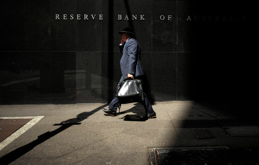 A Sydney businessman walks into the light outside the Reserve Bank of Australia, February 3, 2015. u00e2u20acu201d Reuters pic