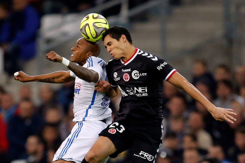 Olympique Marseille's Andre Ayew (left) jumps to head the ball against Aissa Mandi of Stade de Reims during their French Ligue 1 match in Marseille, February 13, 2015. u00e2u20acu201d Reuters pic 