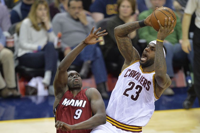 Cleveland Cavaliers forward LeBron James (23) shoots against Miami Heat forward Luol Deng (9) in the third quarter of their NBA game at Quicken Loans Arena in Cleveland Feb 11, 2015; Mandatory Credit: David Richard-USA TODAY Sports