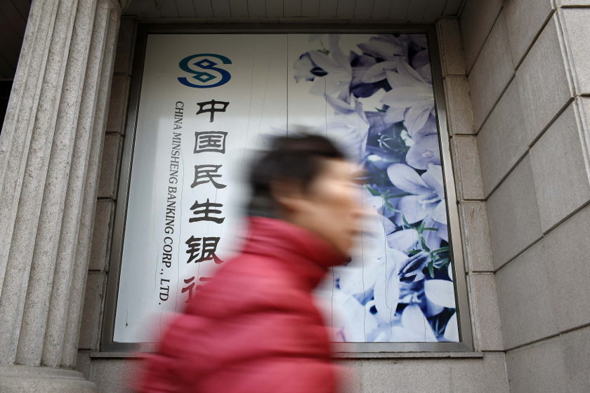 A woman walks past a branch of China Minsheng Bank in Shanghai February 5, 2015. u00e2u20acu201d Reuters pic