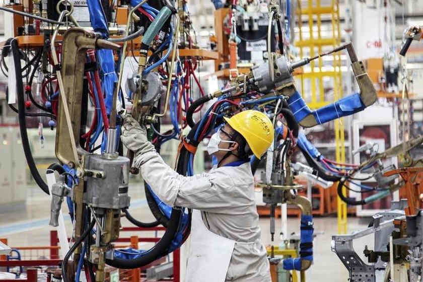 An employee works at the production line of an automobile factory in Dalian, Liaoning province, October 18, 2014. u00e2u20acu201d Reuters pic