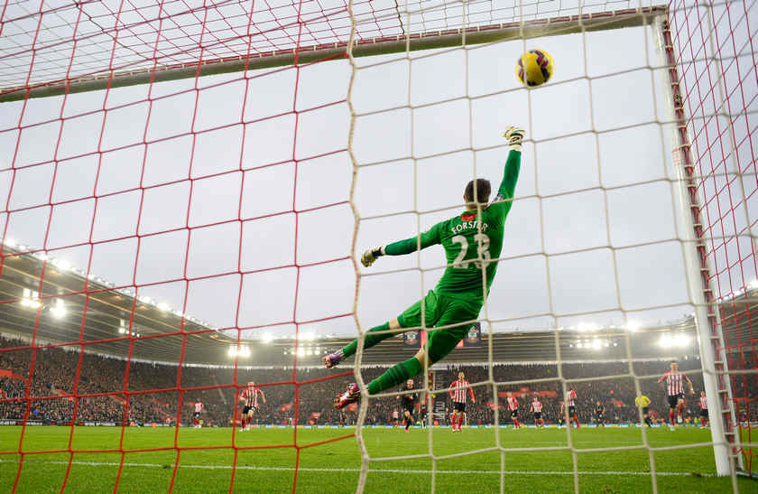 Philippe Coutinho scores the first goal for Liverpool as Southampton's Fraser Forster attempts to save in their English Premier League clash at Southampton February 22, 2015. u00e2u20acu201d Reuters