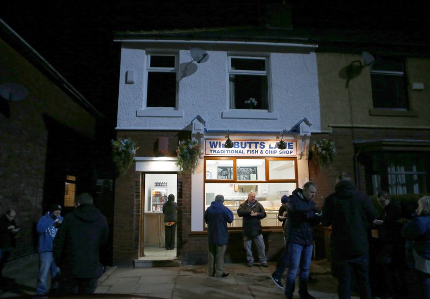 People eat outside a fish and chip shop in Rochdale, northern England January 26, 2015. u00e2u20acu201d Reuters pic