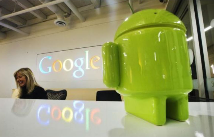 A Google Android figurine sits on the welcome desk as employee Tracy McNeilly smiles at the new Google office in Toronto. u00e2u20acu201d Reuters pic