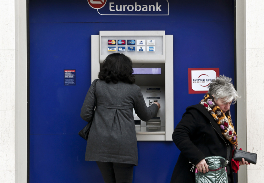 People make transactions at an ATM outside a Eurobank branch in Athens February 14, 2015. u00e2u20acu201d Reuters pic