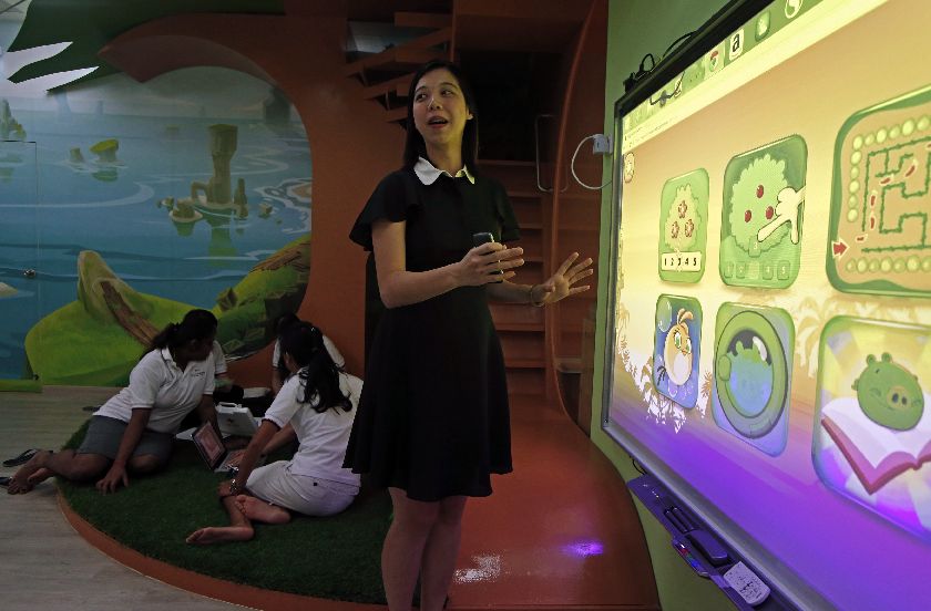 Dreamkids Kindergarten principal Dawn Choy shows how the Smart Board is used for educational games in class as teachers plan their lessons in an Angry Birds-inspired classroom environment in Singapore February 11, 2015. REUTERS/Edgar Su 