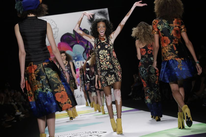 Model Winnie Harlow (C) presents a creation by Desigual at the New York Fashion Week, February 12, 2015.u00c2u00a9AFP PHOTO / JOSHUA LOTT
