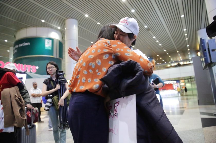 A Chinese MH370 next-of-kin hugs a reporter after arriving at the Kuala Lumpur International Airport, February 12, 2015. u00e2u20acu201d Picture by Choo Choy May