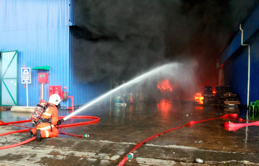 A fireman tries to put out the fire at Kualiti Alamu00e2u20acu2122s Integrated Scheduled Waste Management Centre in Bukit Nanas, Negri Sembilan February 27, 2015. u00e2u20acu201d Bernama pic