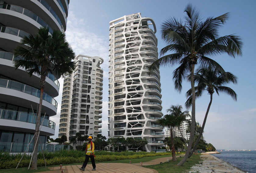 A construction worker passes by the Cape Royale condominium in Sentosa Cove in Singapore in this August 19, 2014 file photo. Construction is one sector in Singapore EVA Capital's Roland Thing is looking at. u00e2u20acu201d Reuters pic