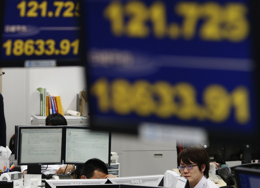 Employees of a foreign exchange trading company work under monitors displaying the Japanese yenu00e2u20acu2122s exchange rate against against the US dollar (top) andJapanu00e2u20acu02dcs Nikkei stock average in Tokyo March 10, 2015. u00e2u20acu201d Reuters pic