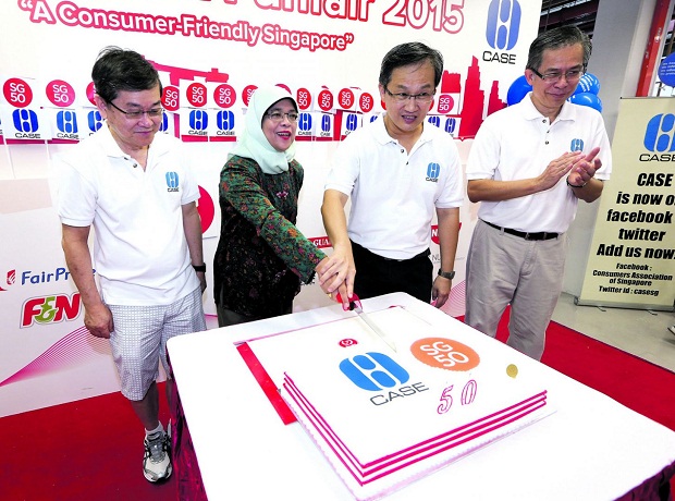 Singapore's Speaker of Parliament Halimah Yacob (centre) at the funfair organised to mark SG50 and World Consumer Rights Day yesterday.u00e2u20acu201d TODAY pic