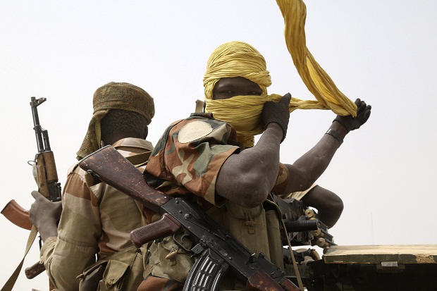 A Chadian soldier fixes his headscarf while driving at the front line during battle against insurgent group Boko Haram in Gambaru, February 26, 2015. u00e2u20acu201d Reuters pic
