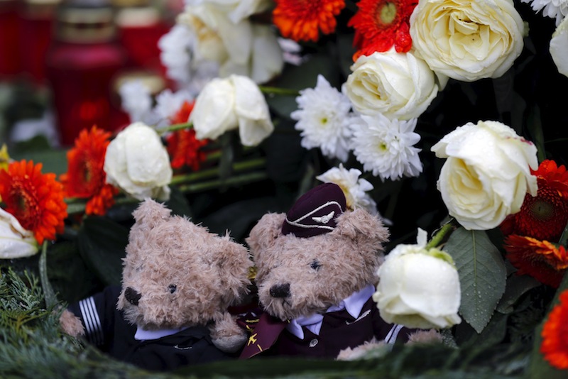 Two teddy bears dressed in the uniforms of a Germanwings pilot and a flight attendant sit in the centre of a wreath outside the Germanwings headquarters at Cologne-Bonn airport March 28, 2015.u00c2u00a0u00e2u20acu201du00c2u00a0Reuters pic