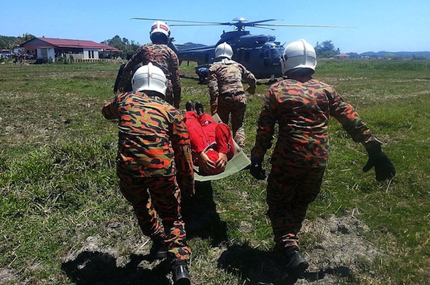 This handout photo taken on and received on March 15, 2015 by the Malaysian Fire and Rescue Department shows personnel carrying an unidentified Indonesian pilot on a stretcher following a crash in Langkawi. u00e2u20acu201du00c2u00a0AFP pic