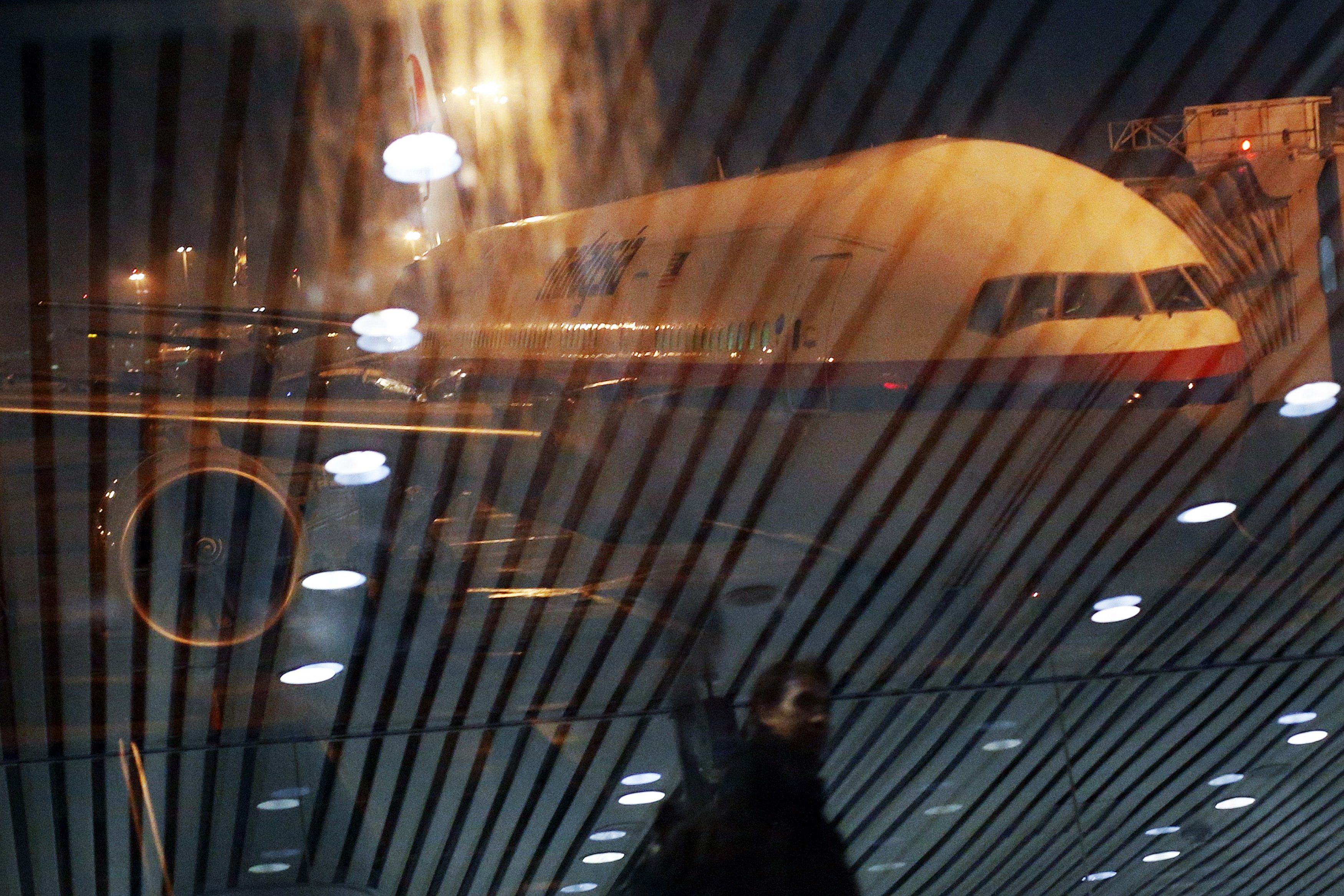 Malaysia Airlines Boeing 777-200ER flight MH318 to Beijing sits on the tarmac as passengers are reflected in the glass at the boarding gate at Kuala Lumpur International Airport at approximately 12:20am in this March 17, 2014 file photo. u00e2u20acu201d Reuters pic