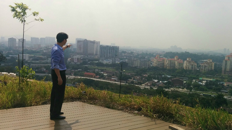 Gasing Meridian Sdn Bhd Marketing Director Leo Tan pointing to the view of Petaling Jaya from the Sanctuary Ridge development. u00e2u20acu201d Picture by Mayuri Mei Lin