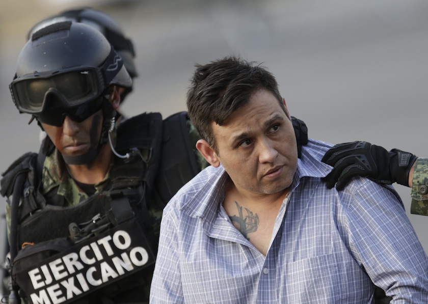 Omar Trevino Morales, known as 'Z-42' and leader of the Zetas drug cartel, is escorted by soldiers during a news conference about his arrest in Mexico City March 4, 2015. u00e2u20acu201d Reuters pic