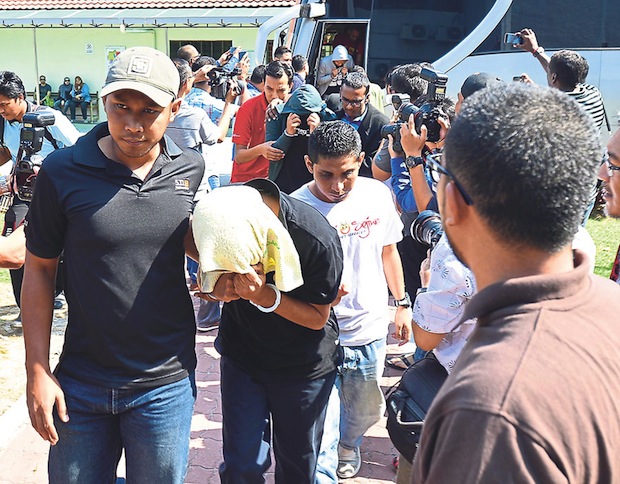 Some of the suspects being led out of the court complex yesterday after their remand order was extended until Thursday. u00e2u20acu201d Pictures by Marcus Pheong