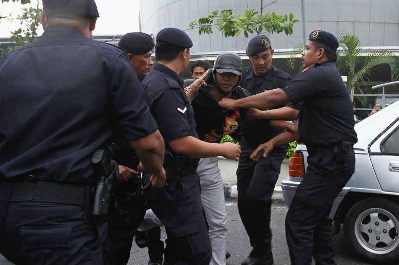 An anti-GST protestor scuffled with police personnel at the Customs office in Kelana Jaya, Kuala Lumpur, March 23, 2015. u00e2u20acu201d Picture by Yusof Mat Isa 