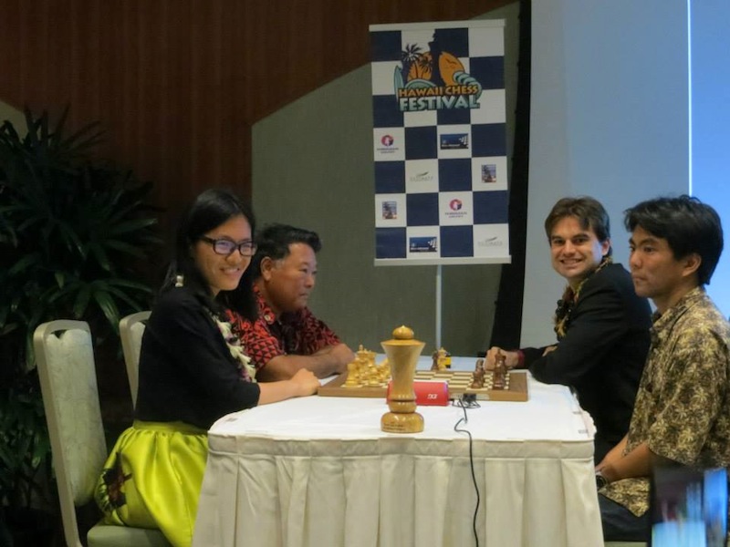 Women's world chess champion Hou Yifan playing an exhibition with the Mayor of Hawaii as her partner.