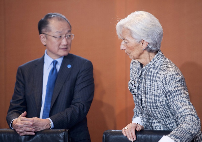 The President of The World Bank Jim Yong Kim and Managing Director of the International Monetary Fund (IMF) Christine Lagarde wait for the start of a meeting of leaders of economic and financial institutions with German Chancellor Angela Merkel, at the Ch