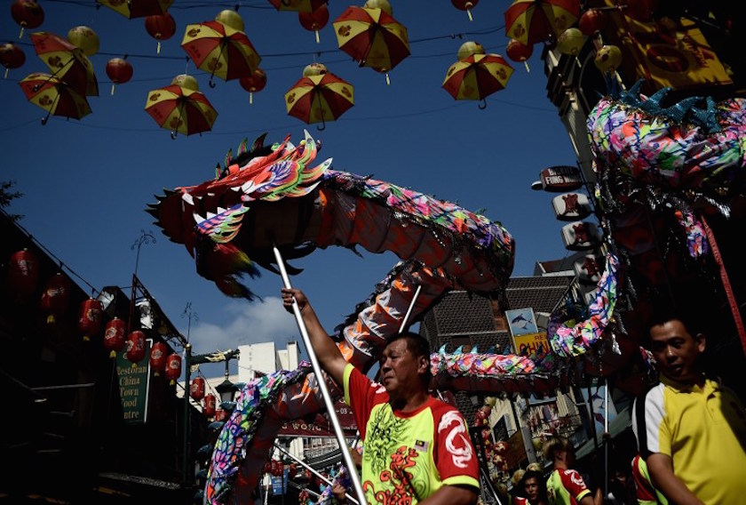 Dancers perform a traditional Chinese dragon dance to celebrate Chap Goh Meh on a street of Chinatown in Kuala Lumpur on March 5, 2015. u00e2u20acu201d AFP pic