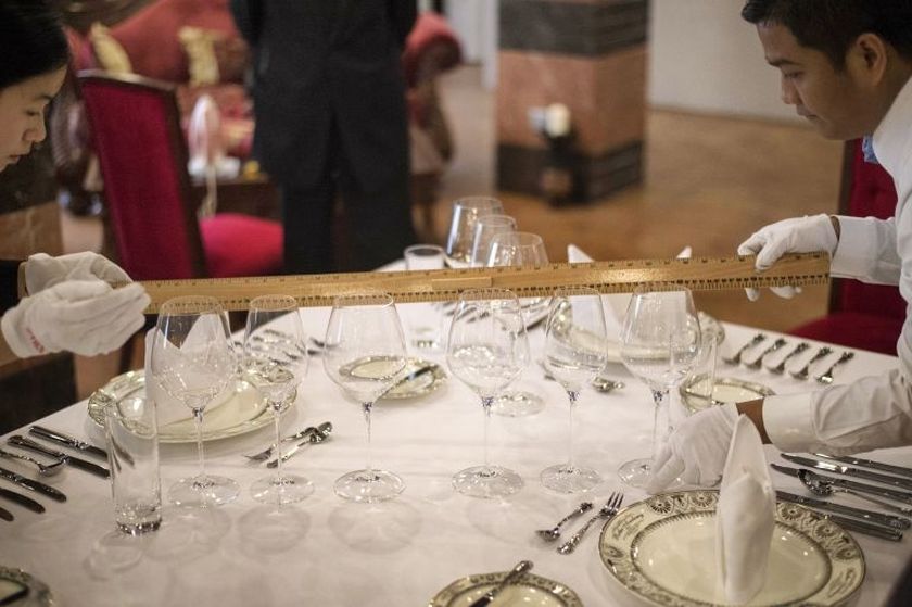 Butlers in training measure the precise distance between cutlery on a table at China's only foreign-run butler school in Chengdu, Sichuan province, on January 23, 2015. u00e2u20acu201d AFP pic